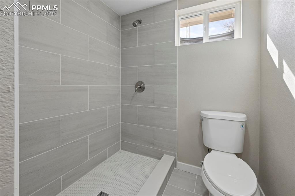 1901 Whitman Road Colorado Springs, CO 80910 - Photo 28 of 35 a white toilet sitting next to a bathroom sink