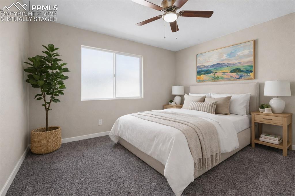 1901 Whitman Road Colorado Springs, CO 80910 - Photo 33 of 35 a spacious bedroom with a bed and a window