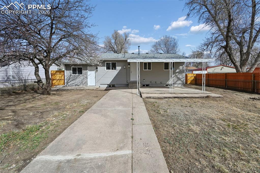 1901 Whitman Road Colorado Springs, CO 80910 - Photo 4 of 35 a front view of a house with a yard and garage