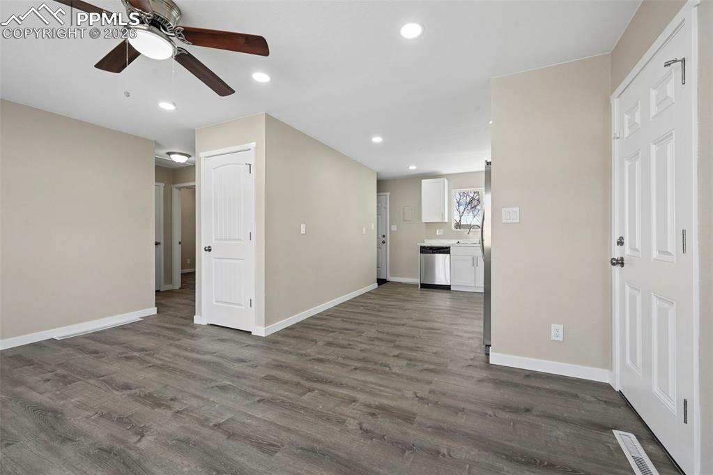 1901 Whitman Road Colorado Springs, CO 80910 - Photo 7 of 35 a view of empty room with wooden floor and ceiling fan