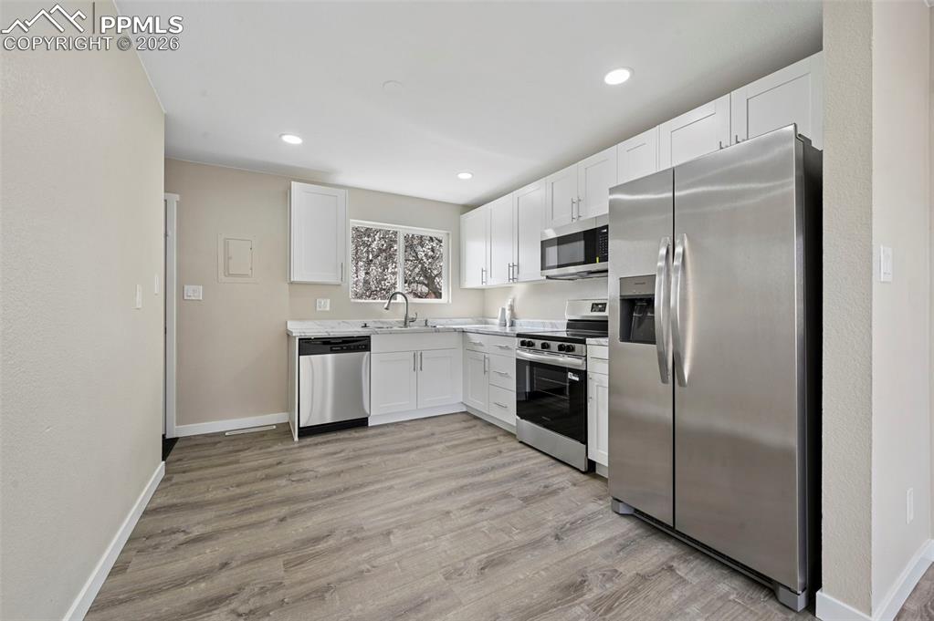 1901 Whitman Road Colorado Springs, CO 80910 - Photo 8 of 35 a kitchen with a refrigerator sink and stove