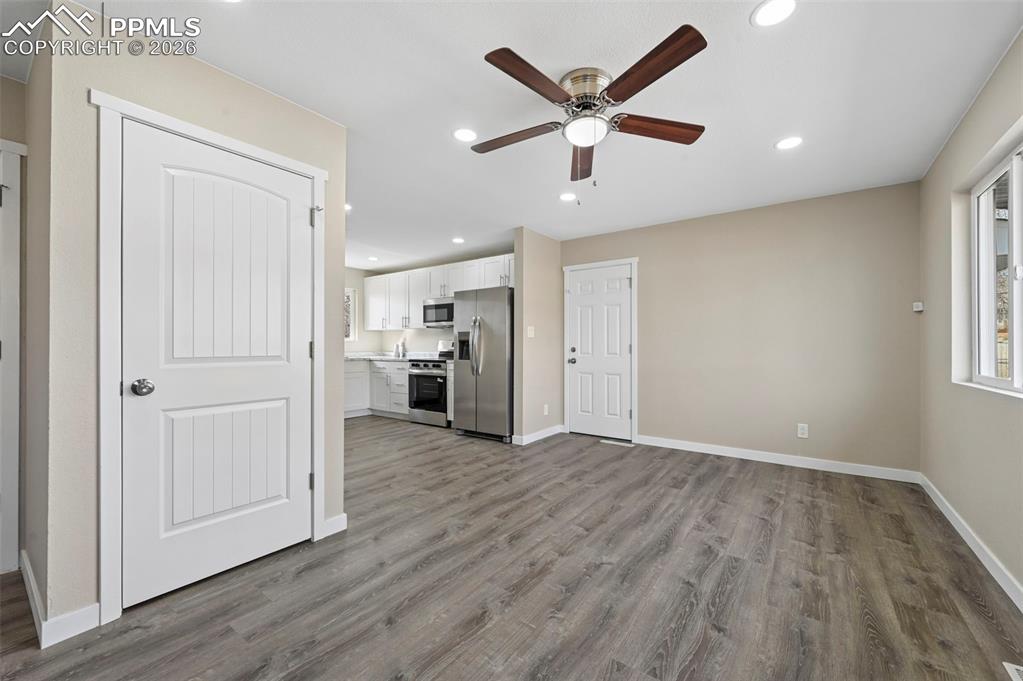 1901 Whitman Road Colorado Springs, CO 80910 - Photo 9 of 35 an empty room with wooden floor and windows