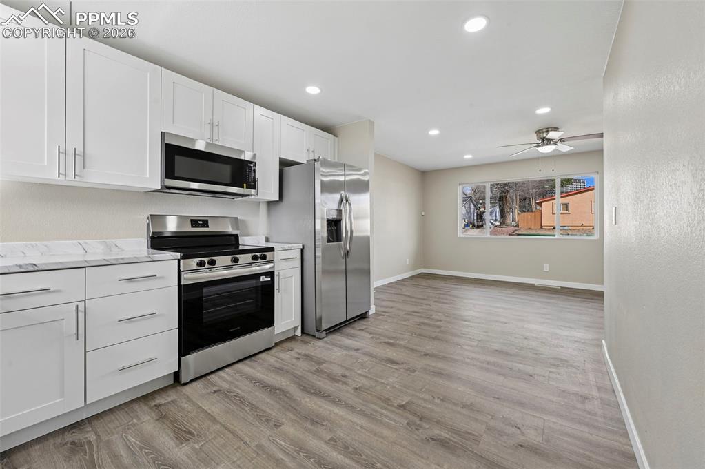 1901 Whitman Road Colorado Springs, CO 80910 - Photo 10 of 35 a large kitchen with stainless steel appliances granite countertop a stove a sink and a refrigerator