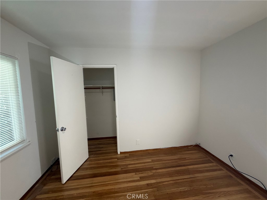 4806 Clarke Street, Unit 2 Oakland, CA 94609 - Photo 11 of 13 a view of an empty room with wooden floor and a window