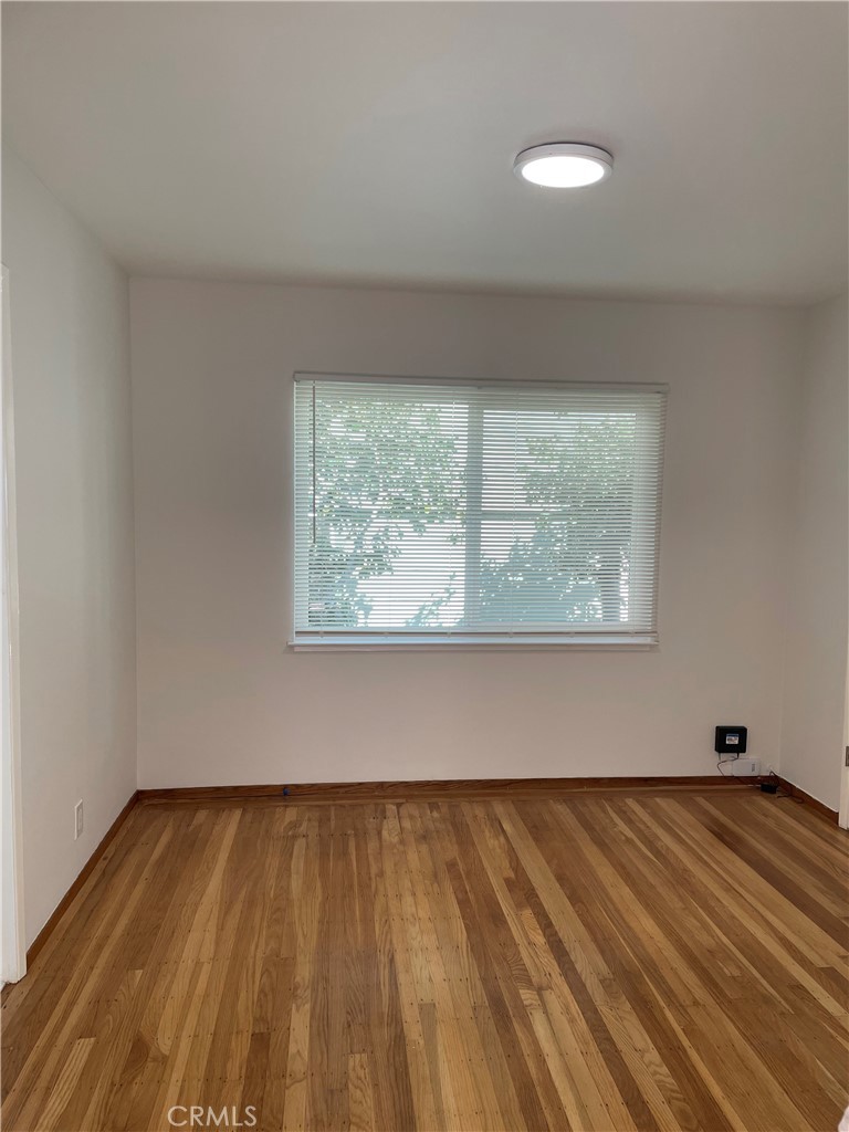 4806 Clarke Street, Unit 2 Oakland, CA 94609 - Photo 3 of 13 a view of a room with wooden floor and window
