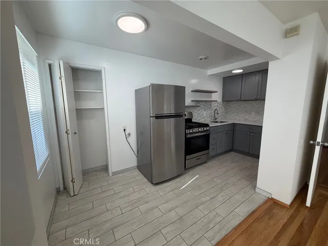 a kitchen with stainless steel appliances granite countertop a refrigerator and a sink
