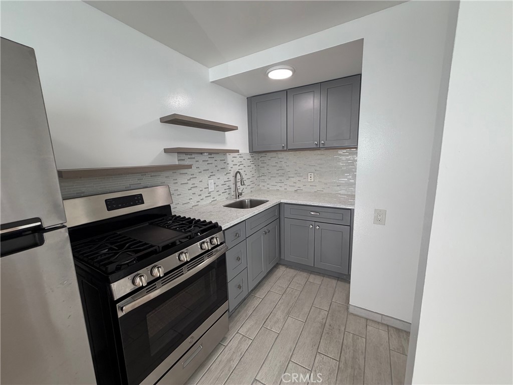 4806 Clarke Street, Unit 2 Oakland, CA 94609 - Photo 6 of 13 a kitchen with a stove and a refrigerator