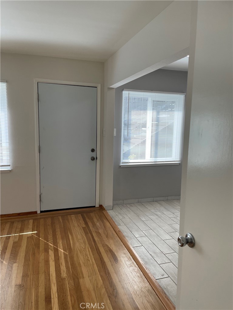 4806 Clarke Street, Unit 2 Oakland, CA 94609 - Photo 9 of 13 a view of an empty room with wooden floor and a window