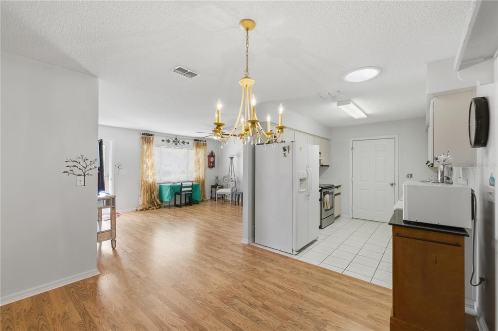 10689 Southeast 174th Loop Summerfield, FL 34491 - Photo 19 of 45 a view of a kitchen with a sink refrigerator and wooden floor