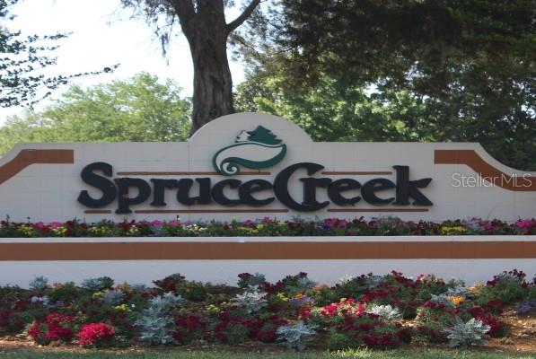 10689 Southeast 174th Loop Summerfield, FL 34491 - Photo 2 of 45 a view of sign board with flower garden