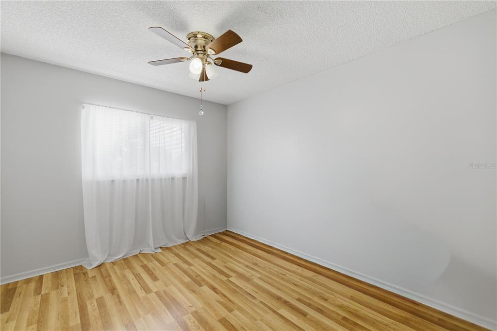 10689 Southeast 174th Loop Summerfield, FL 34491 - Photo 23 of 45 an empty room with a window and a fan