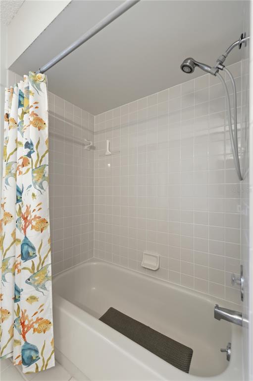 10689 Southeast 174th Loop Summerfield, FL 34491 - Photo 26 of 45 a bathroom with a bathtub and a shower