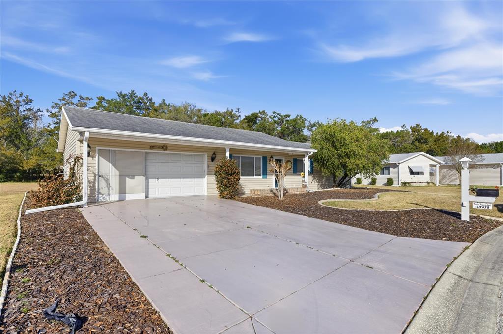 10689 Southeast 174th Loop Summerfield, FL 34491 - Photo 3 of 45 front view of a house with a yard