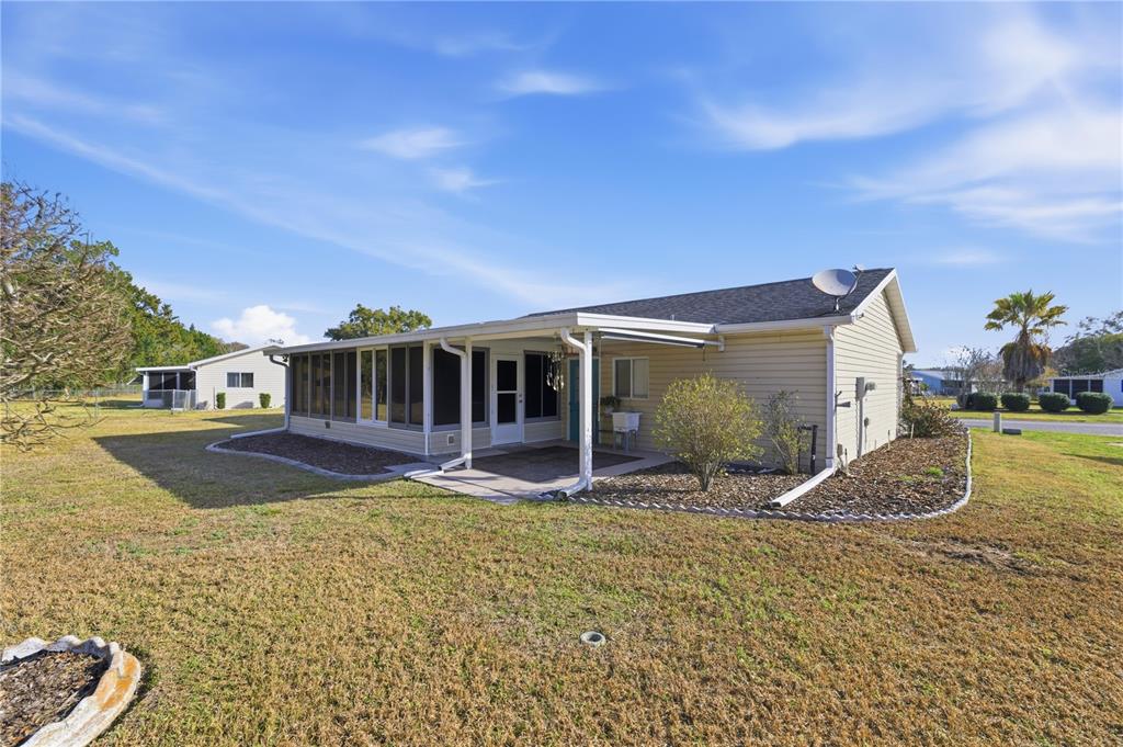 10689 Southeast 174th Loop Summerfield, FL 34491 - Photo 10 of 45 a view of a house with backyard porch and sitting area