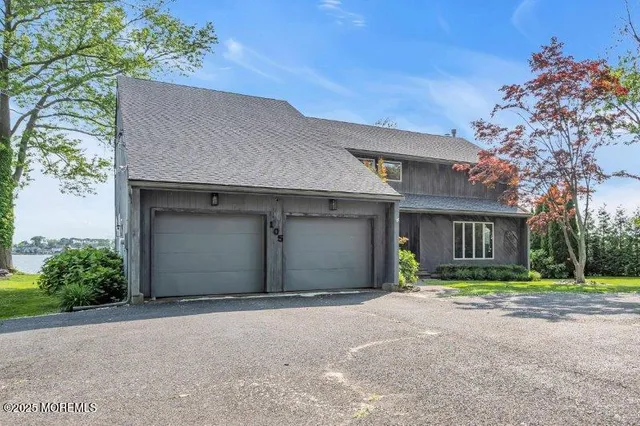 a view of a house with a tree and a yard