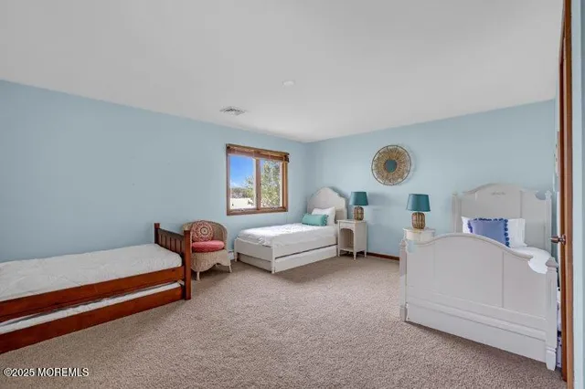 a bedroom with furniture and a large window