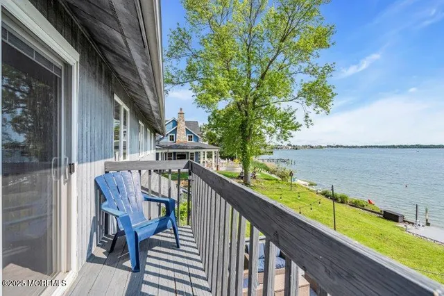 a view of a balcony with two chairs and a potted plant