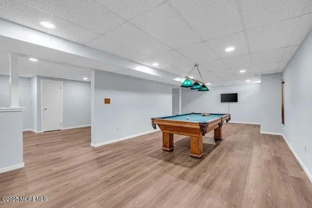 a view of a big house with a big yard and large trees