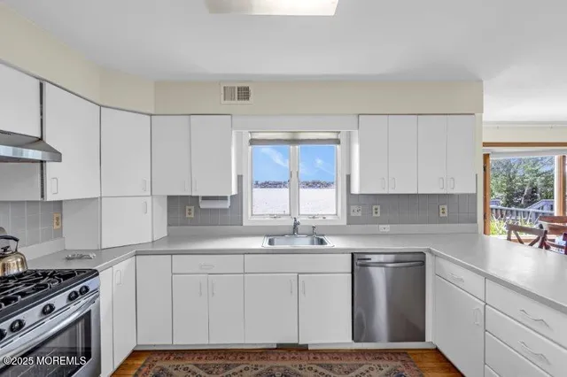 a dining room with furniture a chandelier and wooden floor