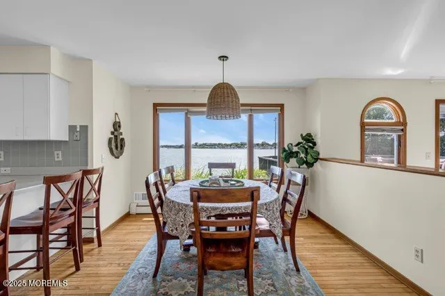 a living room with furniture a flat screen tv and a large window
