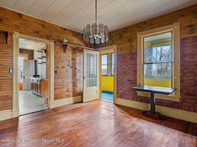 a view of a livingroom with furniture window and wooden floor