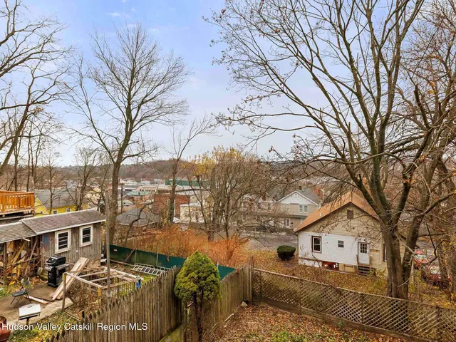 a view of residential houses with trees