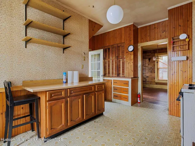 a kitchen with wooden cabinets and center table