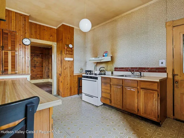 a kitchen with cabinets a sink and appliances