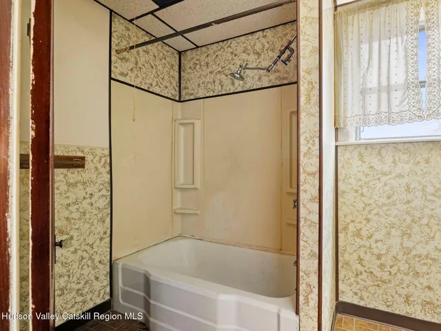 a bathroom with a shower and a sink