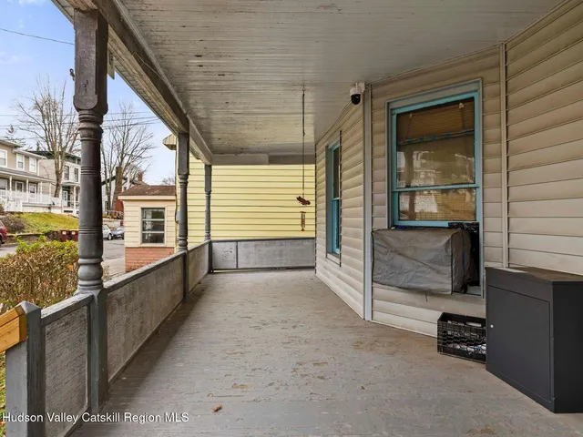 a view of a porch with a table and chair