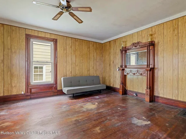 a living room with a bed furniture and a window