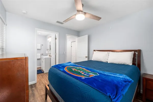 a bedroom with a bed and a lamp