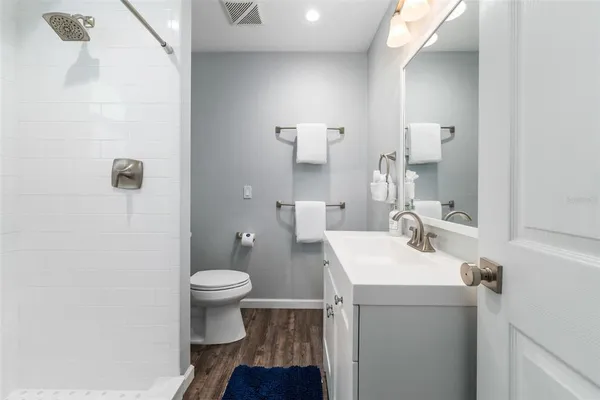 a bathroom with a sink toilet and a mirror