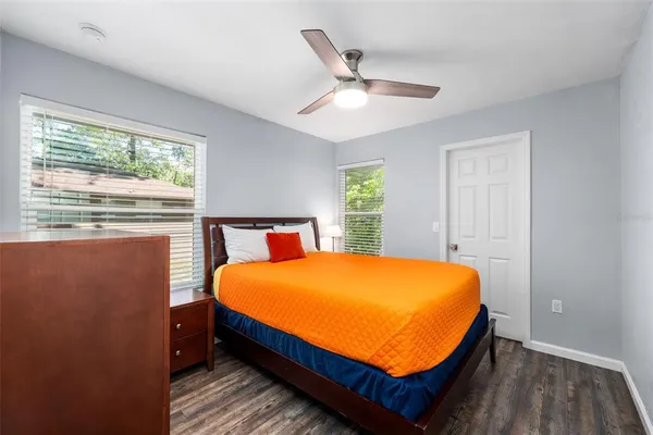 a bed sitting in a bedroom next to a window