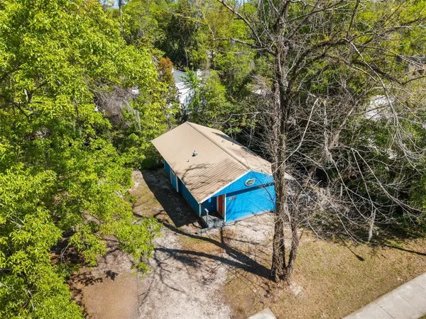 a view of a small house with a yard