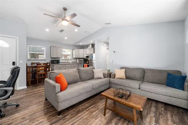 a living room with furniture and kitchen view