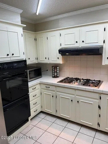 a kitchen with granite countertop cabinets and appliances
