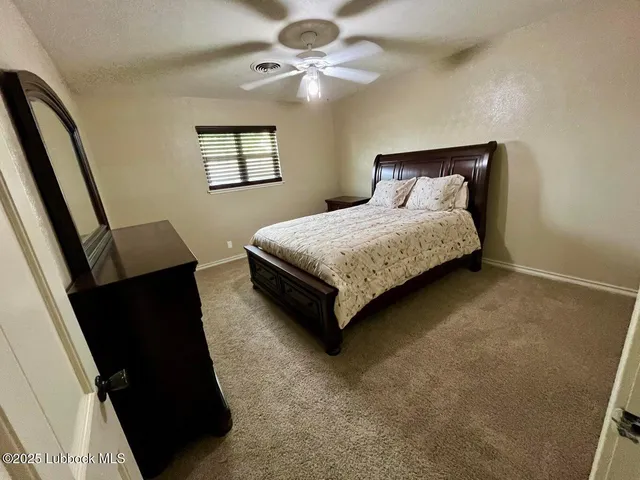 a spacious bathroom with a double vanity sink and a mirror
