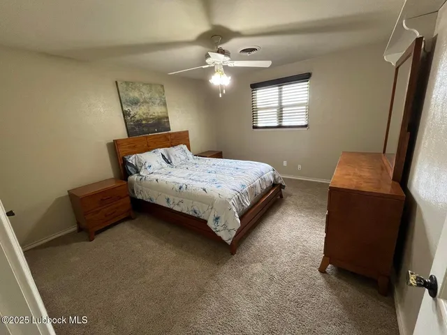 a view of a room with wooden floor and windows