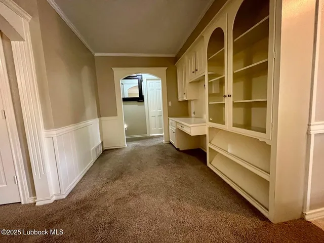 a view of an empty room and a window