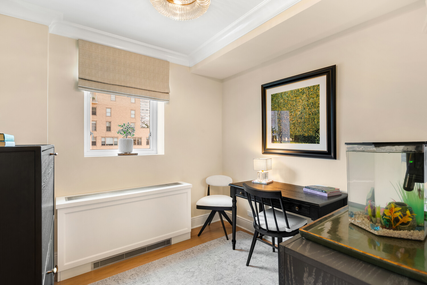 190 East 72nd Street, Unit 14D Manhattan, NY 10021 - Photo 10 of 12 a view of a workspace with furniture and a window