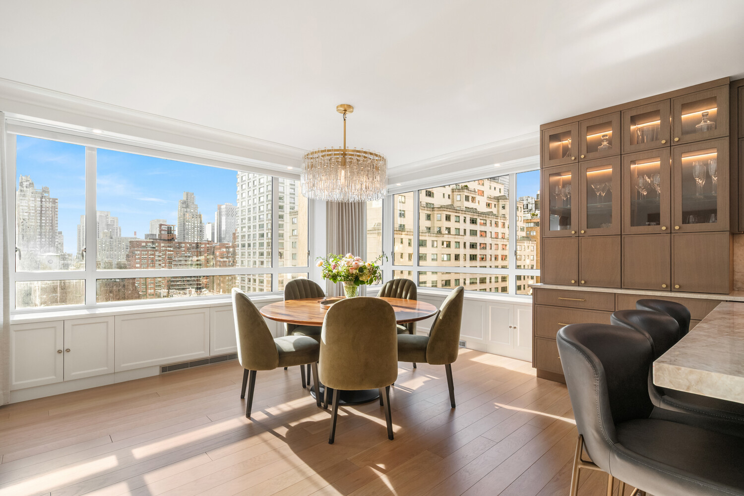 190 East 72nd Street, Unit 14D Manhattan, NY 10021 - Photo 2 of 12 a view of a dining room with furniture large windows and wooden floor
