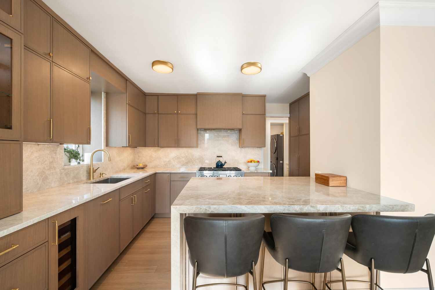 190 East 72nd Street, Unit 14D Manhattan, NY 10021 - Photo 4 of 12 a kitchen with granite countertop a sink and stove