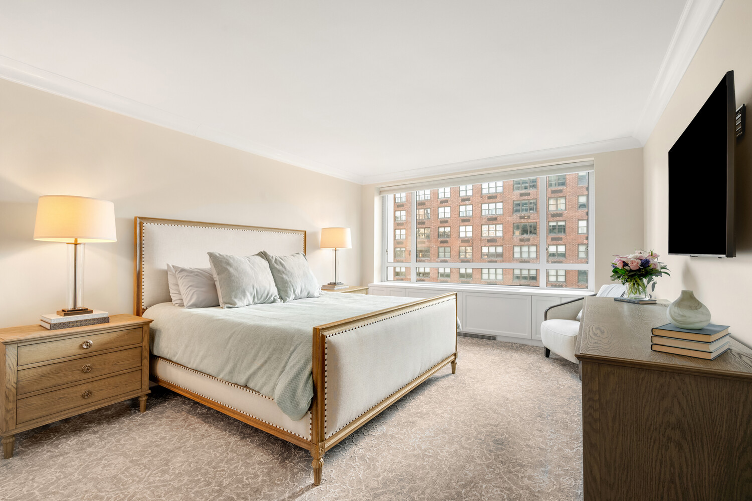190 East 72nd Street, Unit 14D Manhattan, NY 10021 - Photo 7 of 12 a spacious bedroom with a bed and a flat screen tv