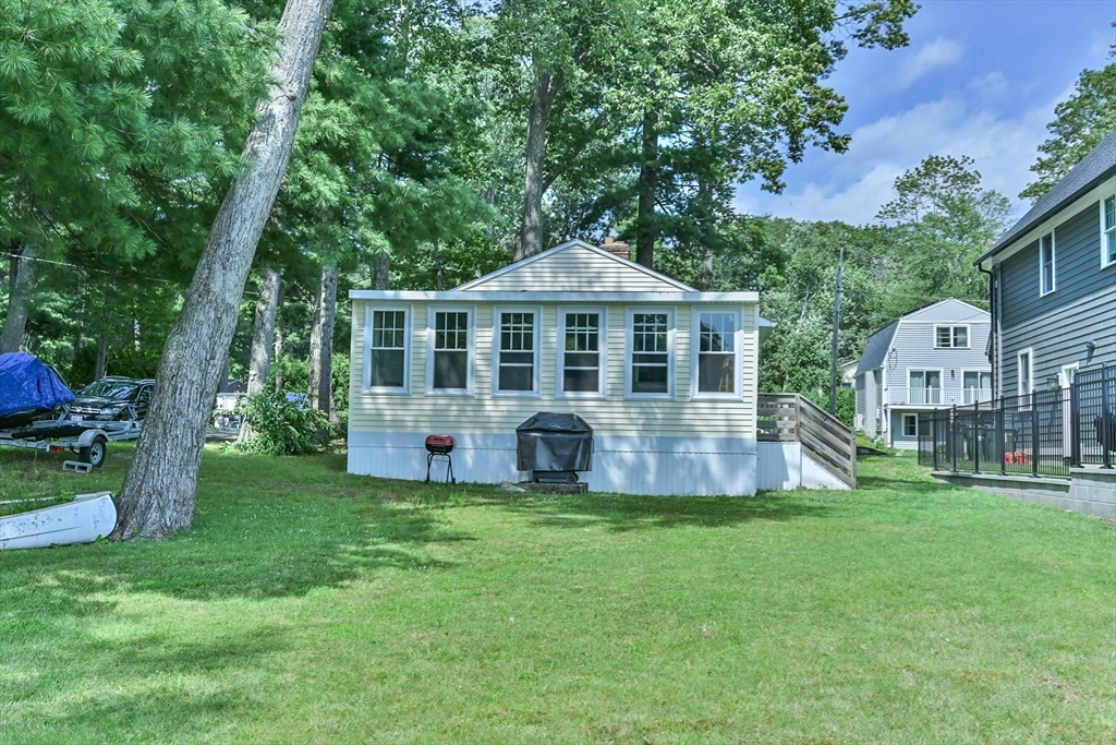23 Lakeview Road Webster, MA 01570 - Photo 11 of 35 a view of a house with a yard and sitting area
