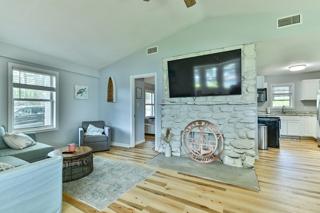 23 Lakeview Road Webster, MA 01570 - Photo 27 of 35 a living room with furniture and a flat screen tv