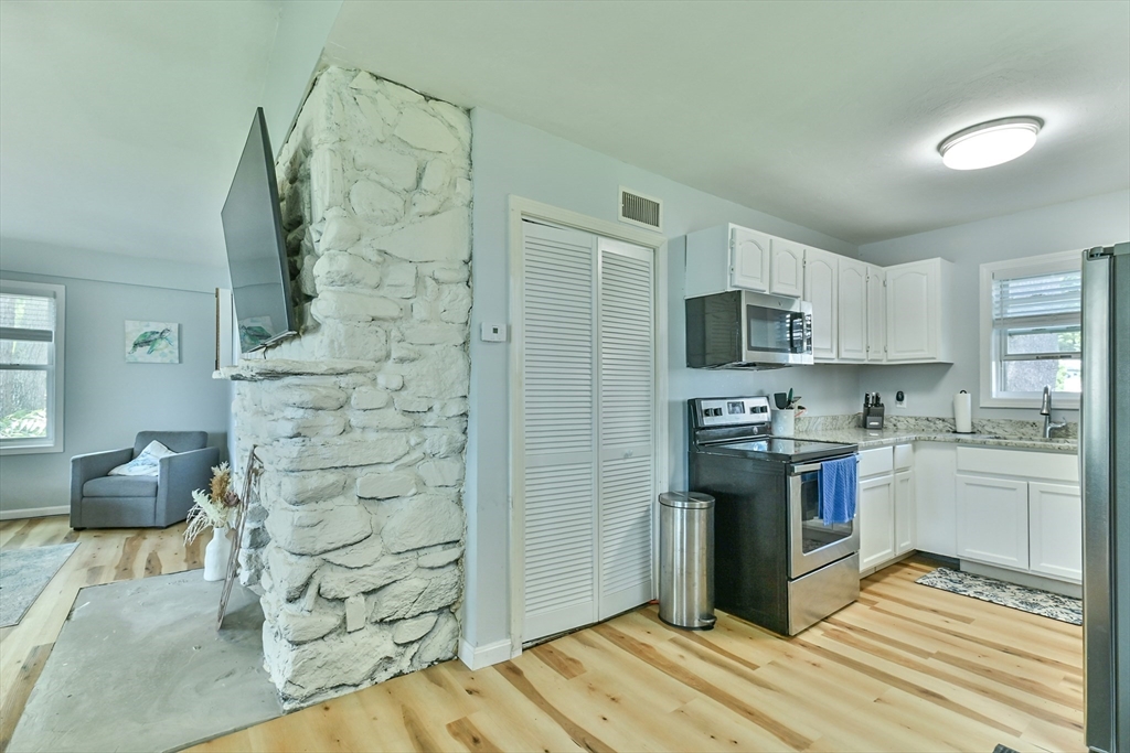 23 Lakeview Road Webster, MA 01570 - Photo 32 of 35 a kitchen with stainless steel appliances granite countertop a refrigerator and a stove top oven