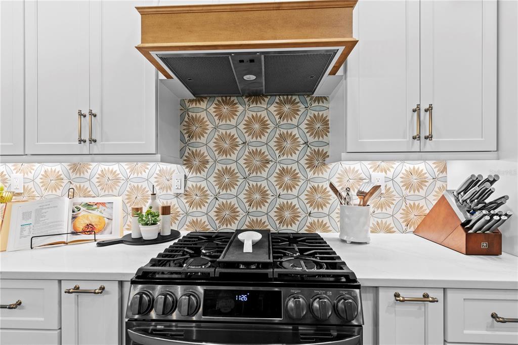 11981 Southwest 1st Road Gainesville, FL 32607 - Photo 16 of 49 a kitchen with granite countertop a stove and a sink