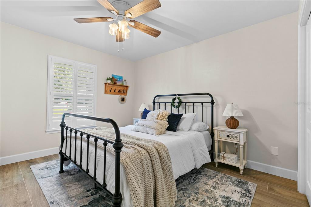 11981 Southwest 1st Road Gainesville, FL 32607 - Photo 19 of 49 a bedroom with a bed and a chandelier