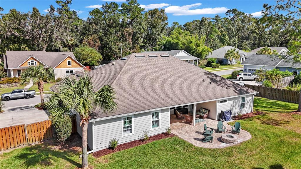11981 Southwest 1st Road Gainesville, FL 32607 - Photo 44 of 49 a aerial view of a house with table and chairs under an umbrella
